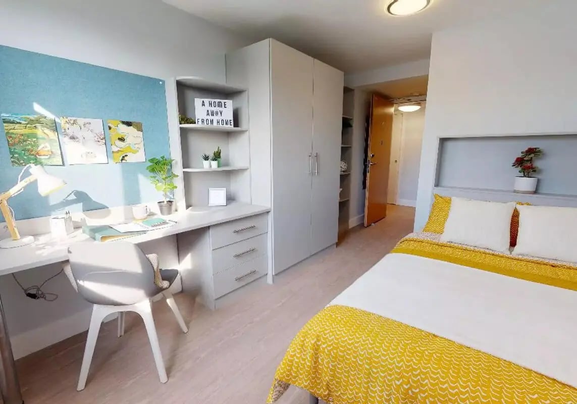 Desk bed wardrobe and door bedroom interior at iQ Hoxton in London Student Accommodation