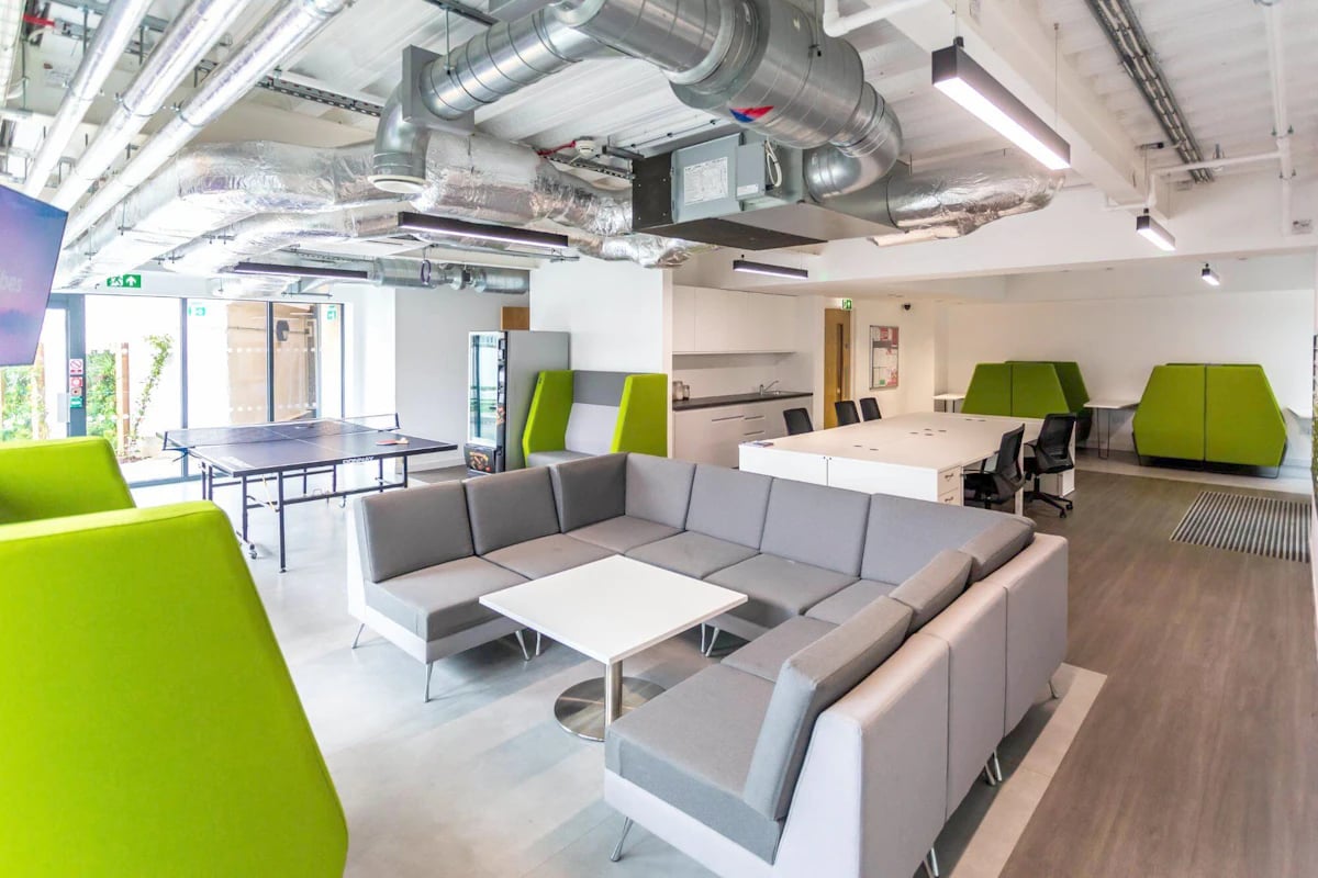 Sofa ping pong table desks green pods common area at Holden Court in Brighton Student Accommodation