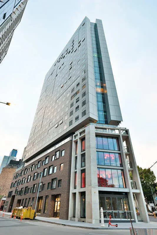 Modern high rise building with large windows exterior at Scape Victoria Street in Melbourne Student Accommodation