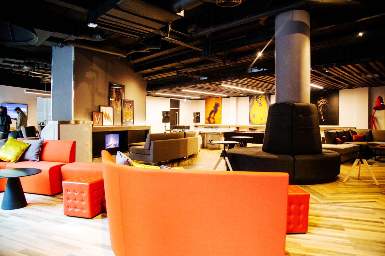 Orange couches and ottomans living room at Vita Student Newcastle Westgate in Newcastle Upon Tyne Student Accommodation