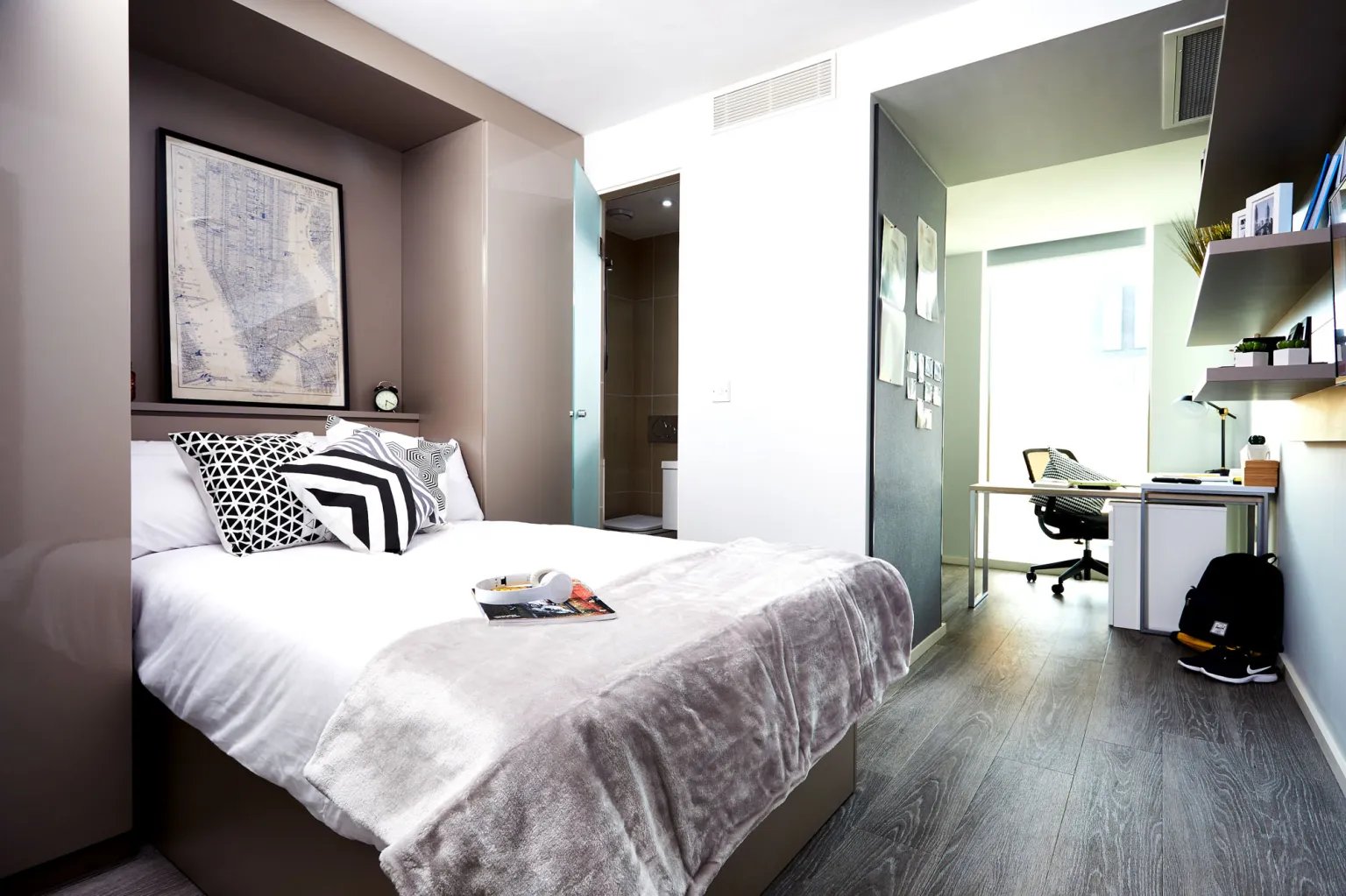 Bed with patterned pillows desk and chair bedroom at Vita Student Manchester First Street in Manchester Student Accommodation