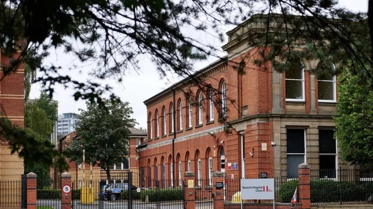 Red brick building with arched windows exterior at Queen's Hospital Close in Birmingham Student Accommodation