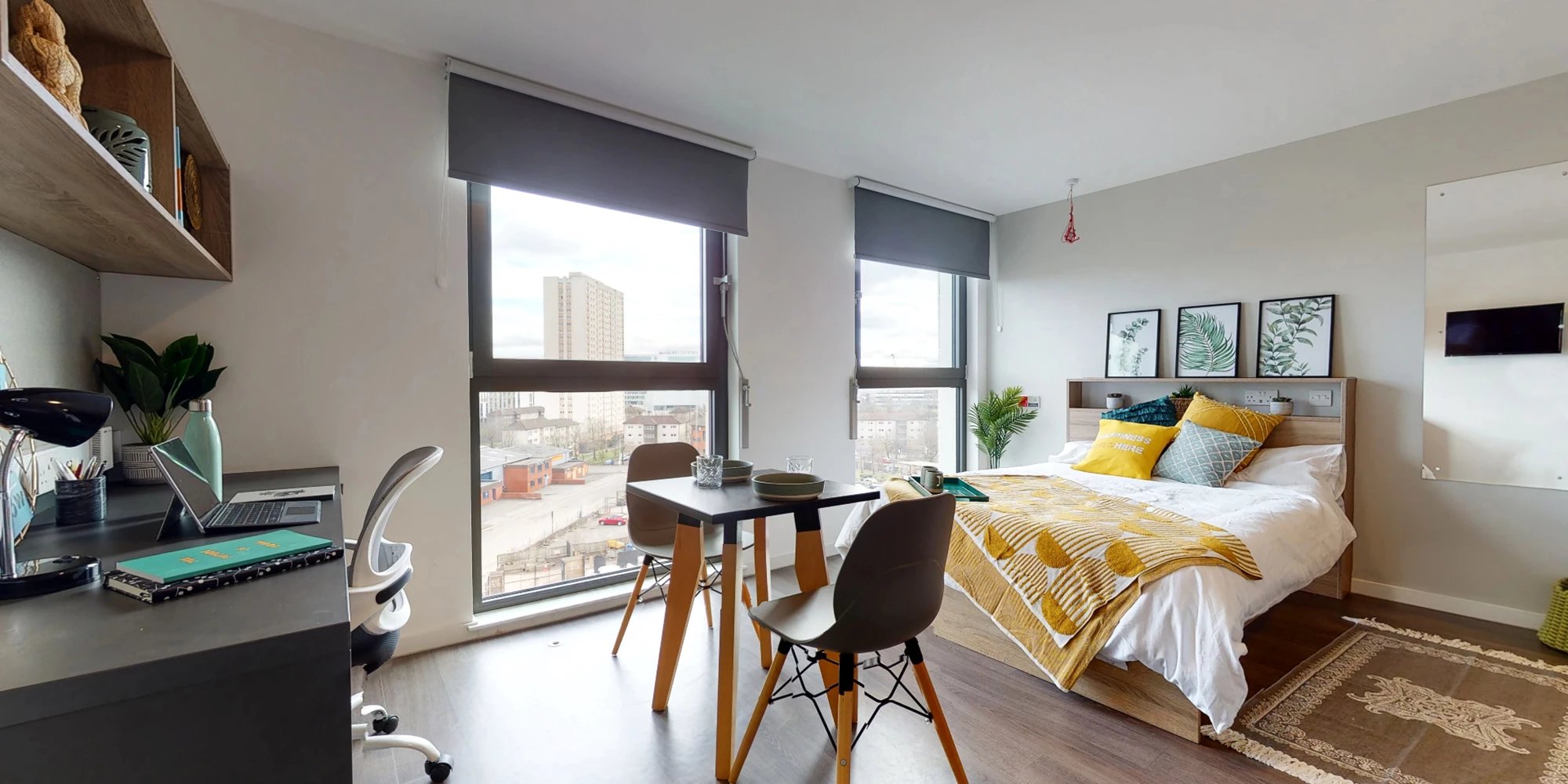 Bed desk chairs table and window bedroom at Canvas Glasgow in Glasgow Student Accommodation