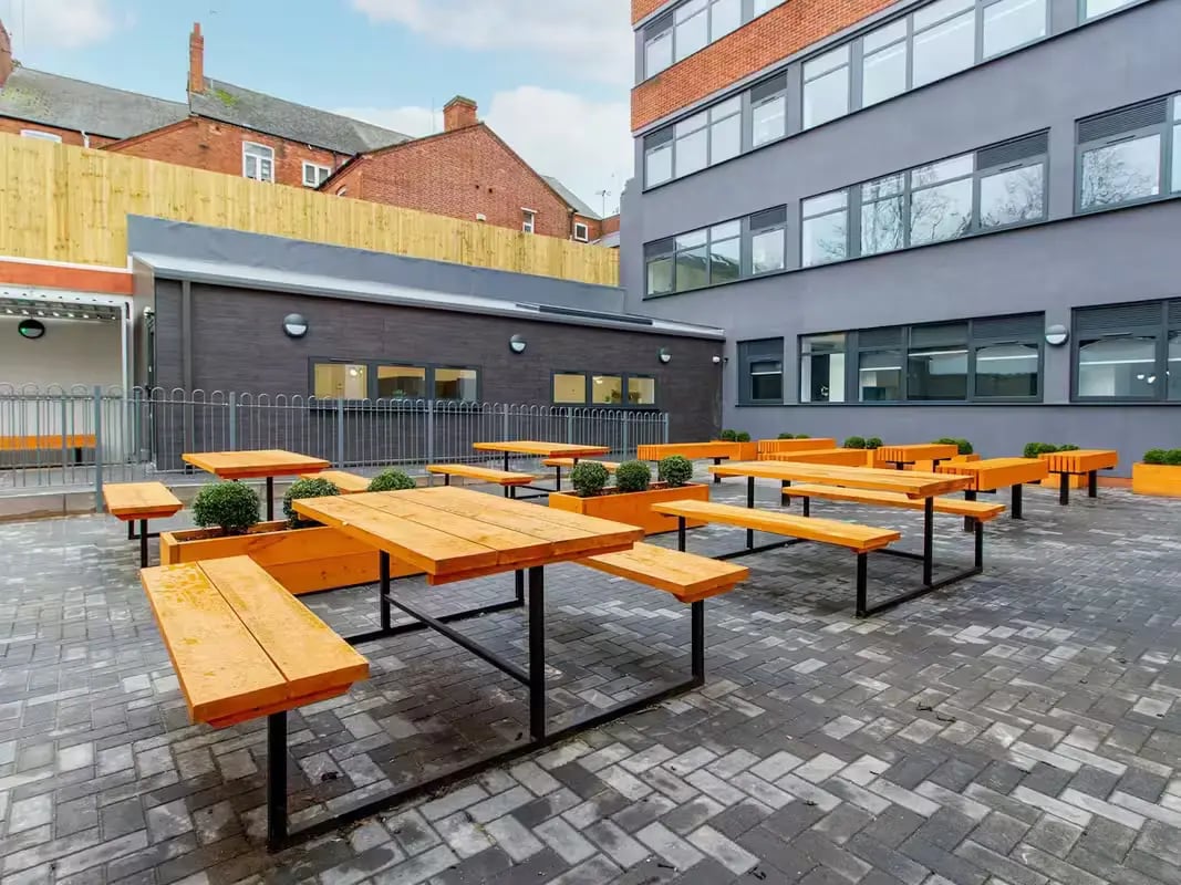 Outdoor picnic tables and benches communal area at Urban Student Village in Coventry Student Accommodation