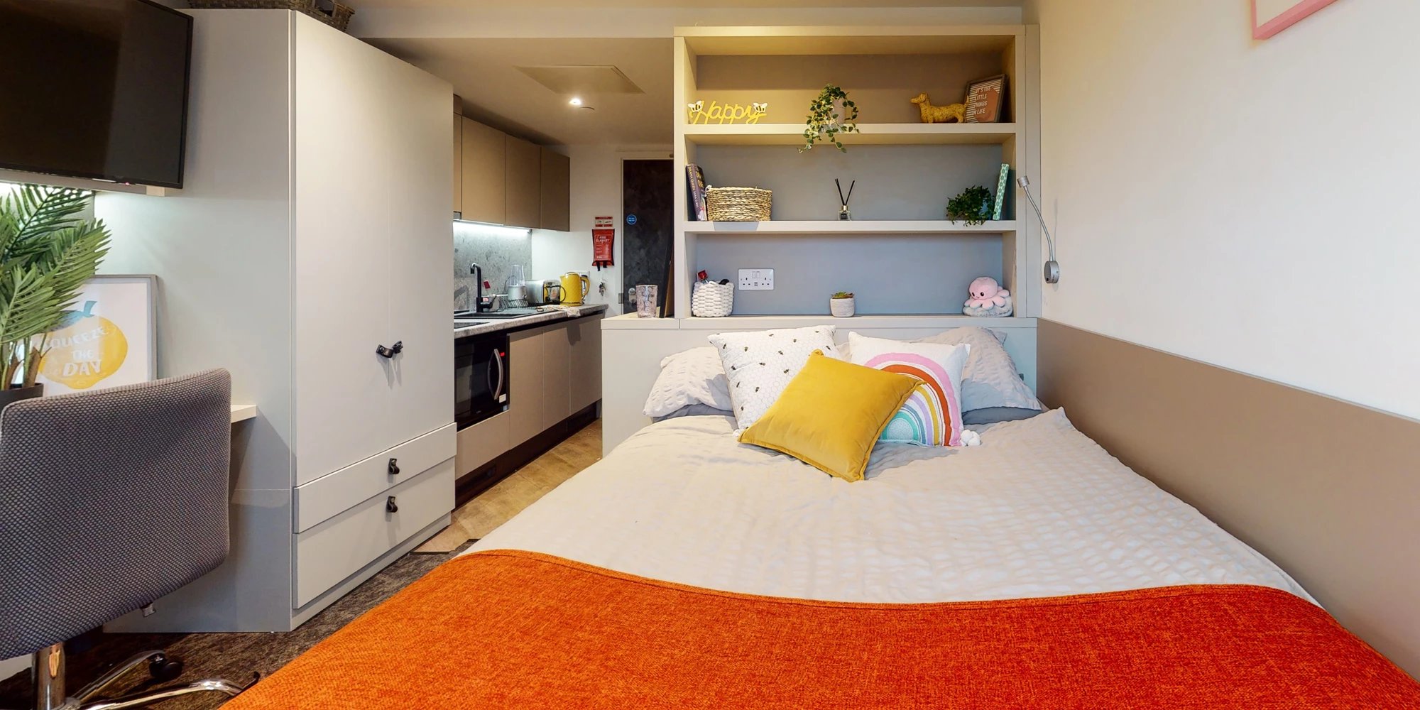 Bed desk kitchen shelves and TV bedroom at Canvas Manchester in Manchester Student Accommodation