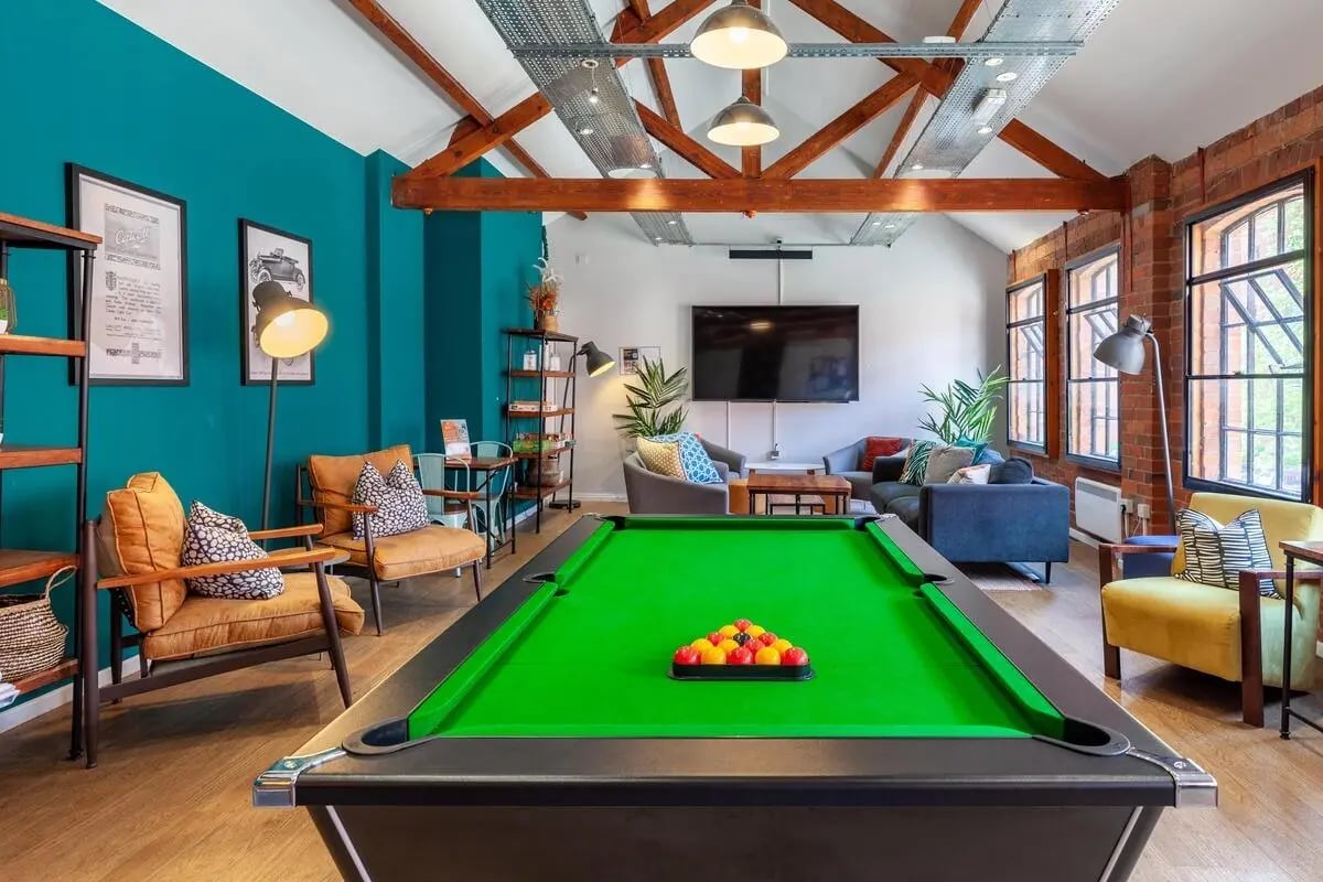 Billiard table sofas chairs television living room at Calcott Ten in Coventry Student Accommodation