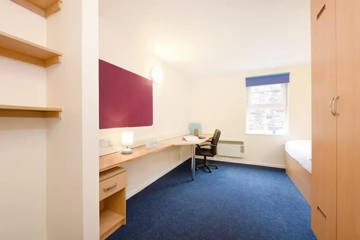 Desk chair shelves and bed student room at Snowdon Hall in Wrexham Student Accommodation