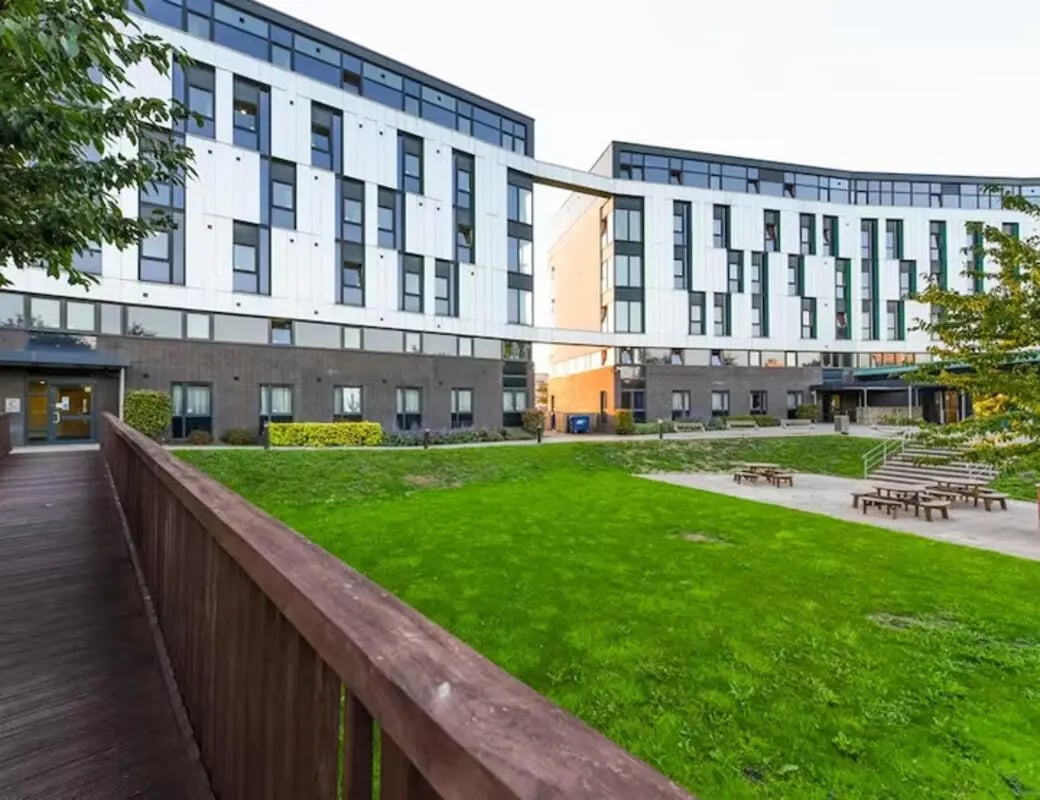 Modern student accommodation building with green lawn exterior at Nottingham Two in Nottingham Student Accommodation