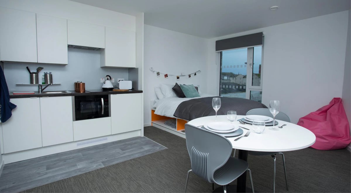 Modern studio kitchen bed dining table beanbag living area at Fraser Studios in Aberdeen Student Accommodation