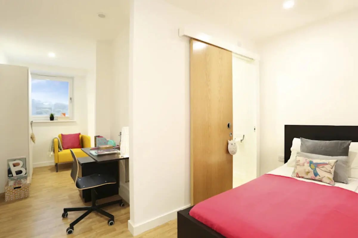 Desk chair yellow chair bed with pink cover bedroom at Keele House in Newcastle Under Lyme Student Accommodation