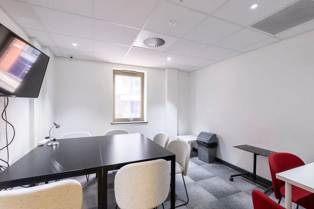 Conference table chairs television trash bin meeting room at Bailey Street in Sheffield Student Accommodation