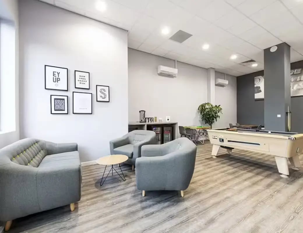 Sofa chairs coffee table pool table communal area at Central Place in Sheffield Student Accommodation
