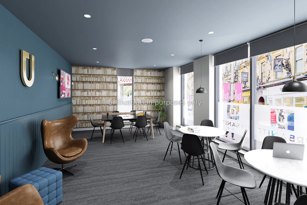 Bookshelf wallpaper chairs tables and laptop communal area at Clyde Court in Glasgow Student Accommodation