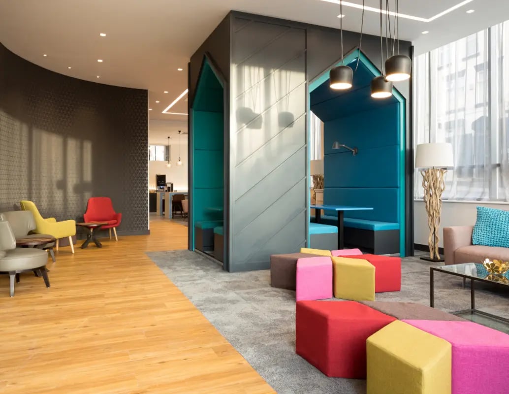 Colorful ottomans booth seating coffee table living room at The Ascent in Liverpool Student Accommodation