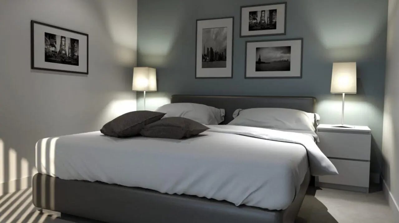 Bed with pillows lamps and framed art bedroom at Nebula in Sheffield Student Accommodation