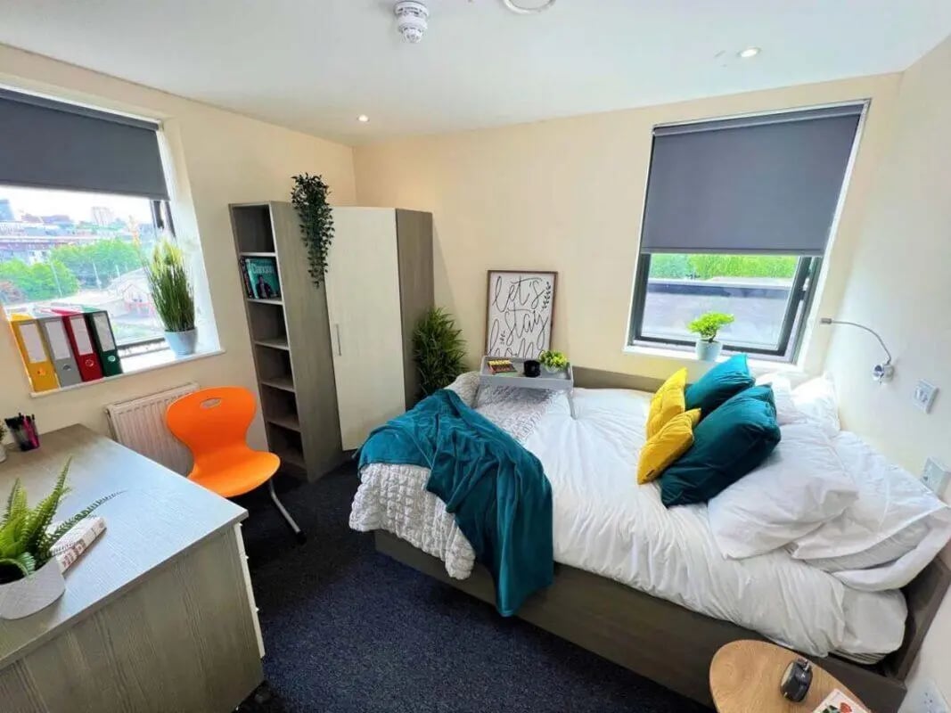 Bed desk wardrobe bookshelf window bedroom at Stratus in Sheffield Student Accommodation