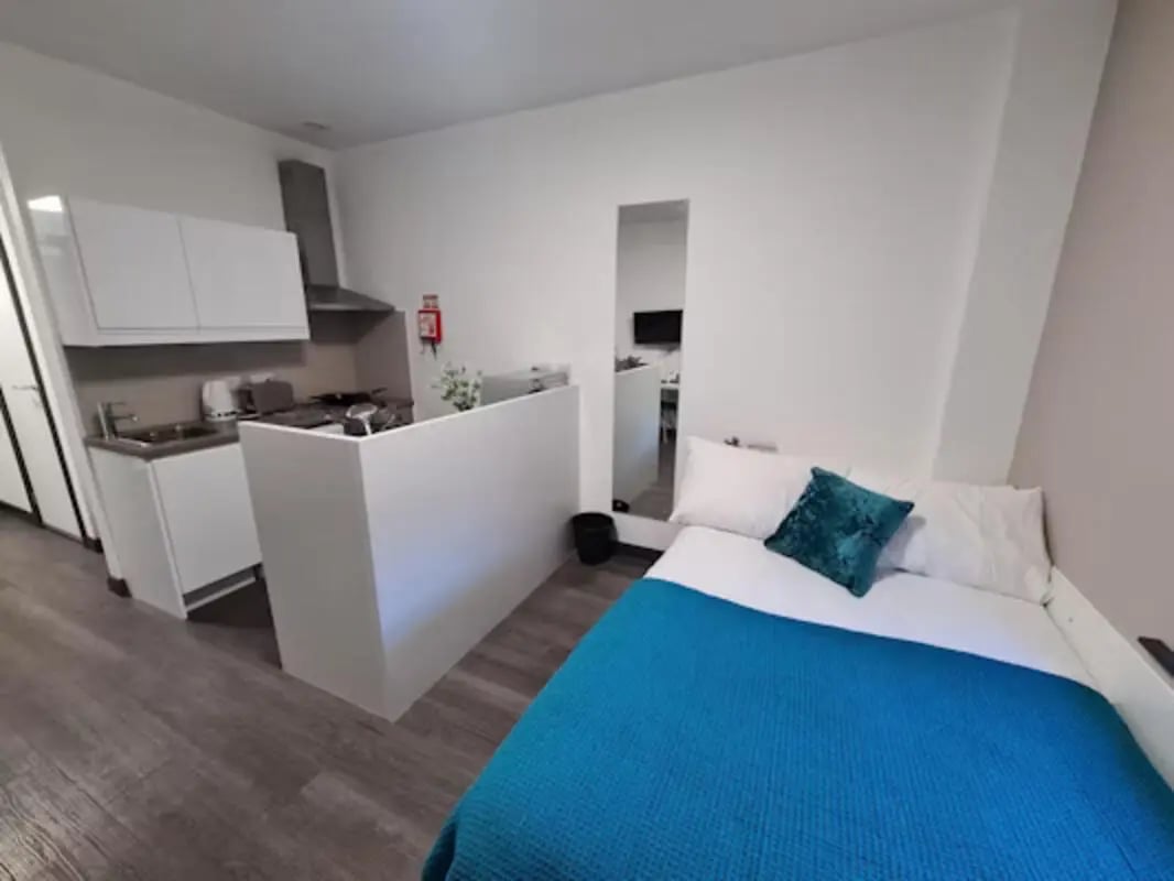 Bed kitchen white cabinets and oven living room at St James House in Newcastle Upon Tyne Student Accommodation