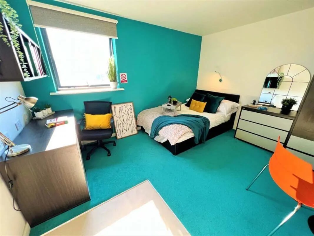 Bed desk chair and framed art bedroom at Plato House in Liverpool Student Accommodation