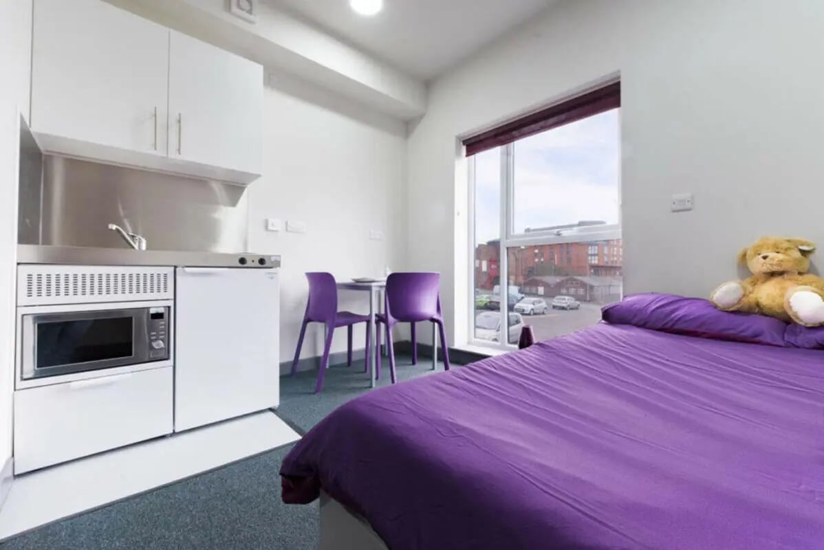 Studio kitchen microwave bed and chairs living room at Stoke Student Village in Stoke-On-Trent Student Accommodation