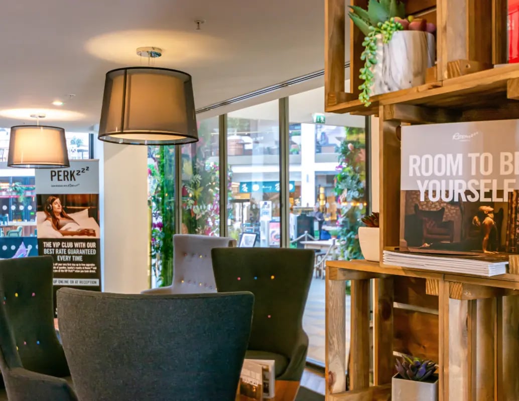 Lounge area with chairs and wooden shelves Living room at Manchester Victoria in Manchester Student Accommodation