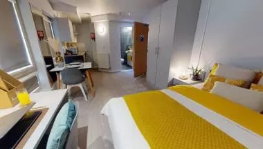 Bed desk kitchen bathroom student studio apartment at iQ Broderick House in Birmingham Student Accommodation