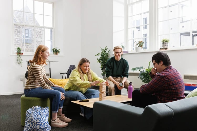 Students playing Jenga in living room common area at Causeway View in Aberdeen Student Accommodation