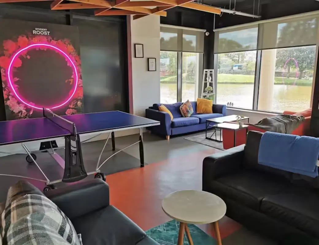 Ping pong table couches and neon art living room at The Towpath in Chester Student Accommodation