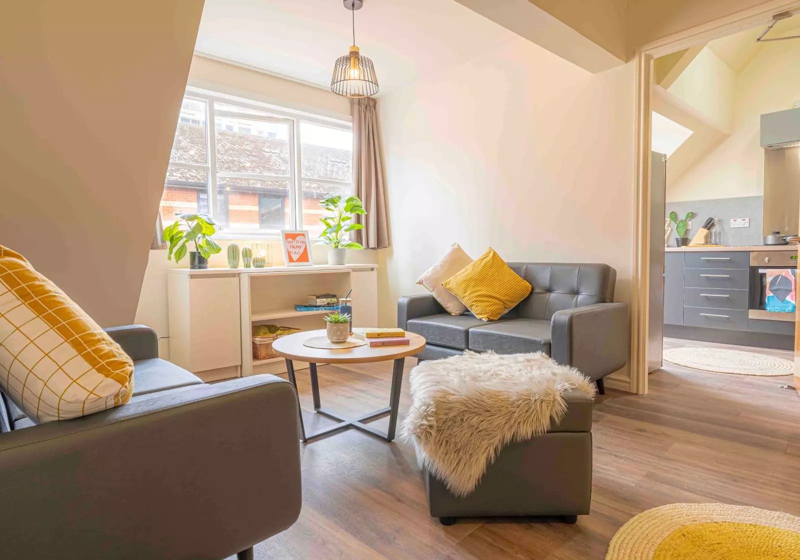 Sofa table plants and shelving living room at iQ Fletcher House in Manchester Student Accommodation