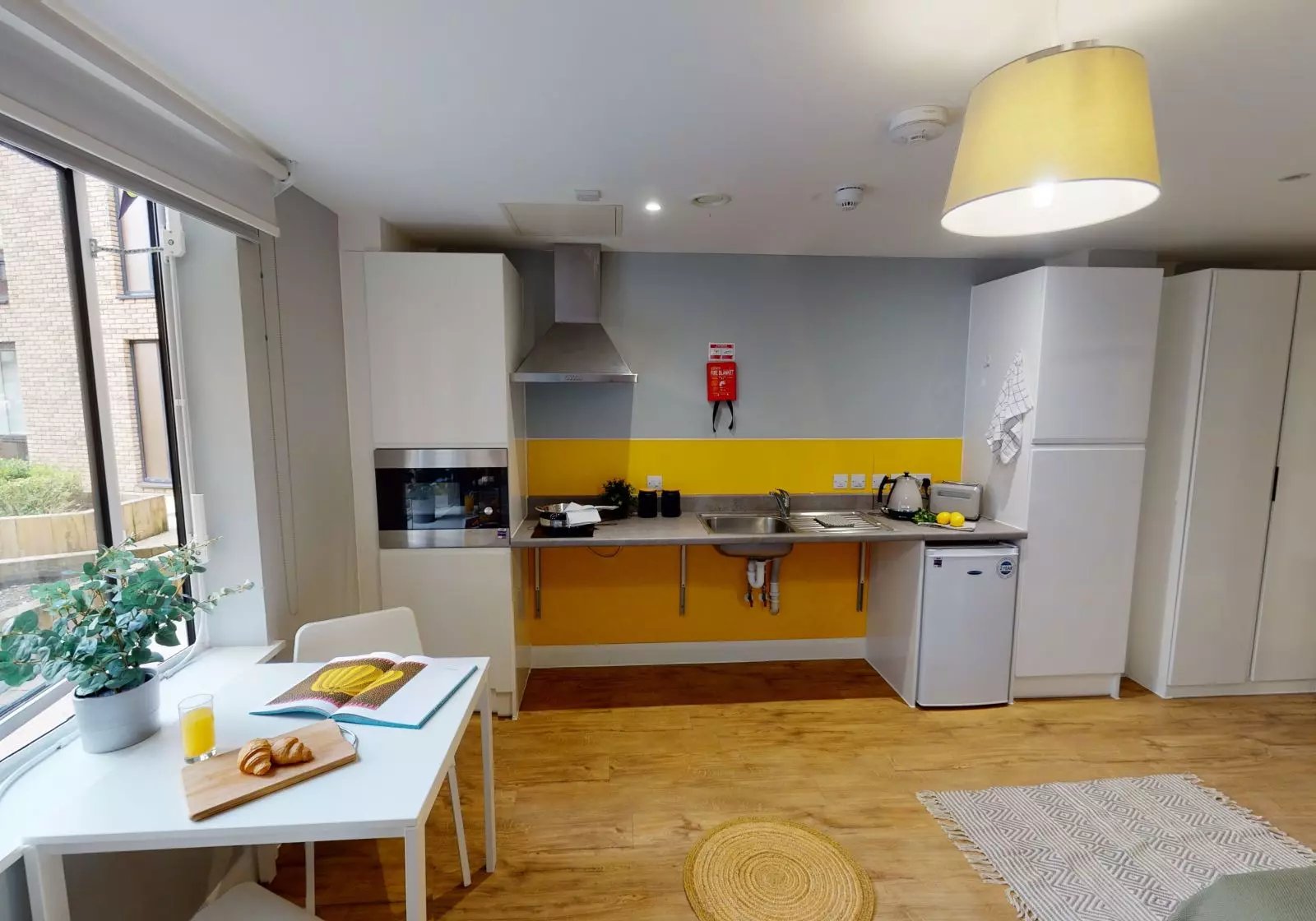 White table, kitchen with sink, microwave, toaster kitchen at iQ The Brickworks in York Student Accommodation
