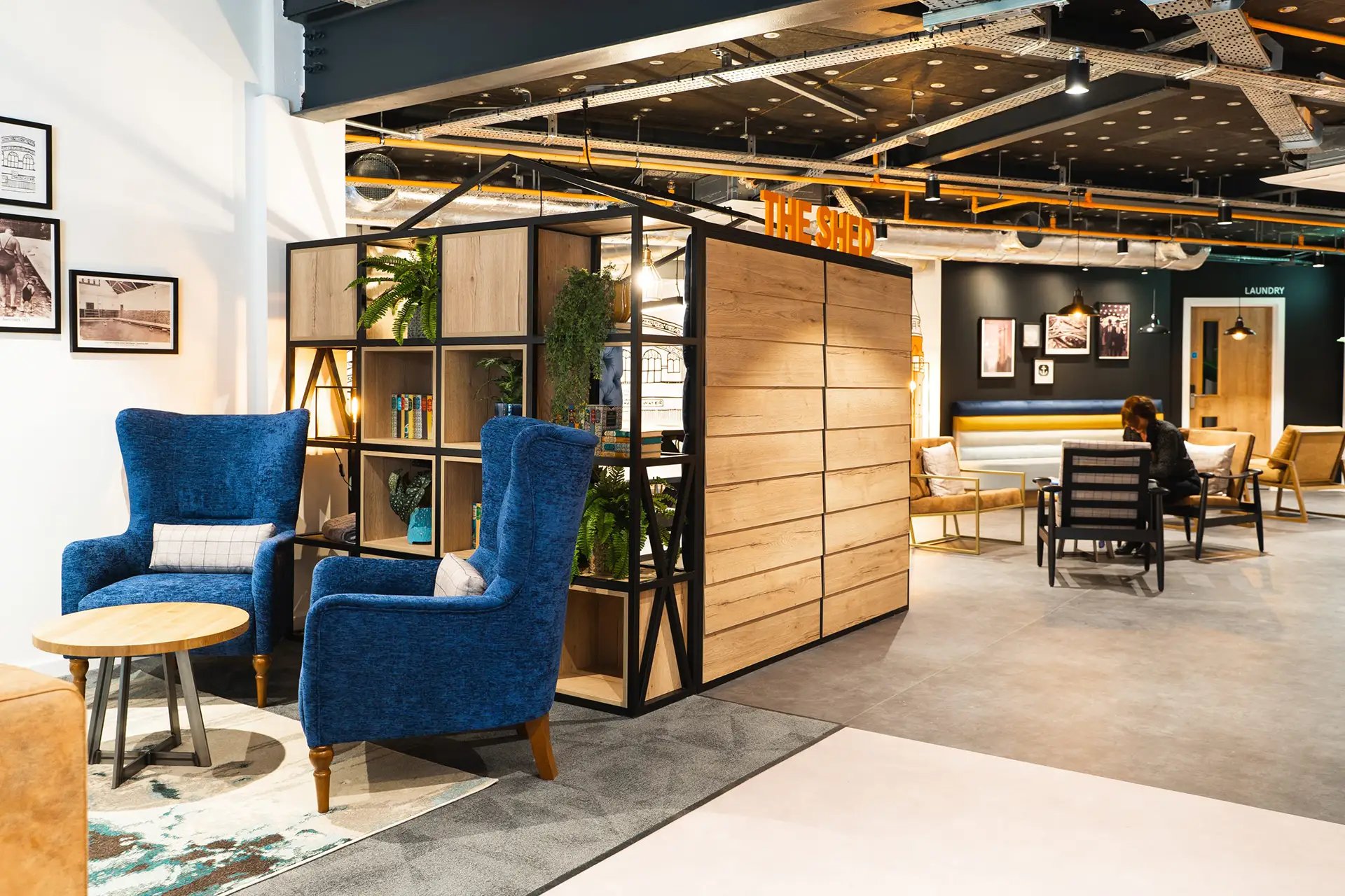 Two blue armchairs and a round coffee table communal area at Altura Birmingham in Birmingham Student Accommodation