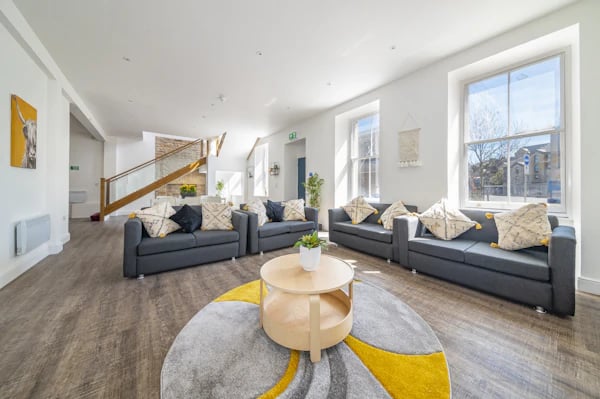 Grey sofas round coffee table large living area at Foundry Studios in Lancaster Student Accommodation
