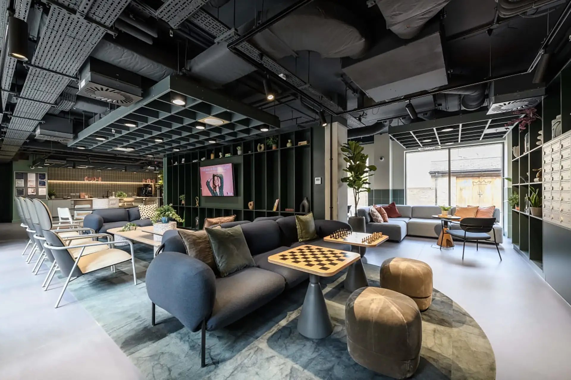 Sofas chess tables ottomans lounge area at Huxley Studios in Edinburgh Student Accommodation