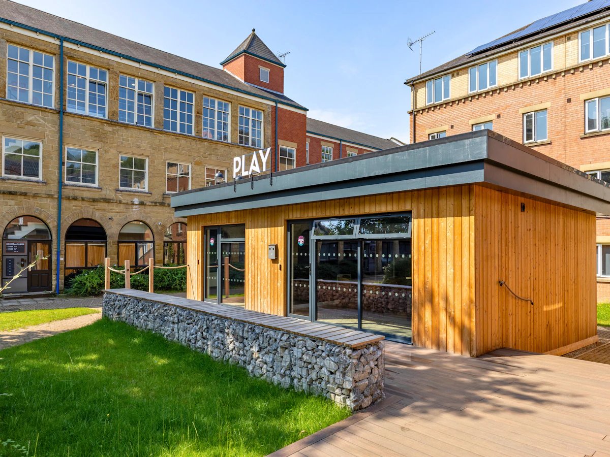Wooden play building with large windows exterior at The Leather Works in Leeds Student Accommodation