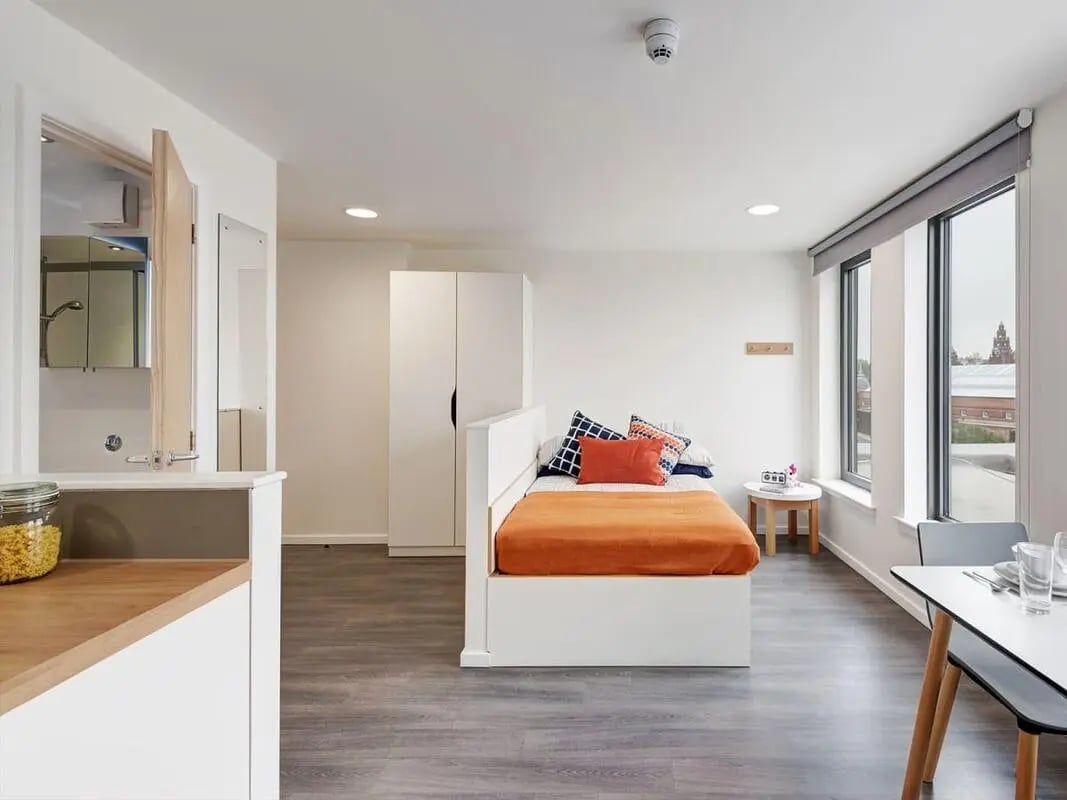 Bed wardrobe small table and desk studio apartment at Dunaskin Mill in Glasgow Student Accommodation
