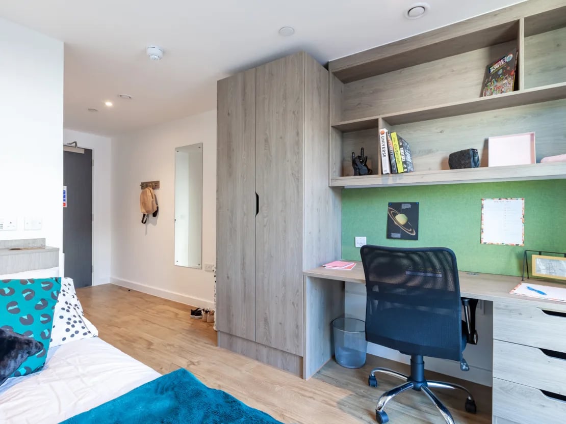 Desk chair shelves and wardrobe student bedroom at Pavilion Point in Brighton Student Accommodation