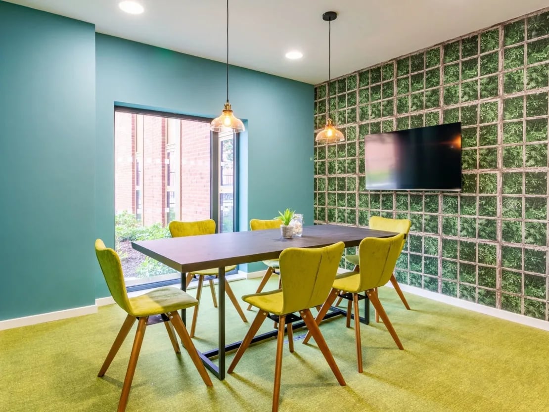 Table chairs plant and TV common area at Gulson Gardens in Coventry Student Accommodation