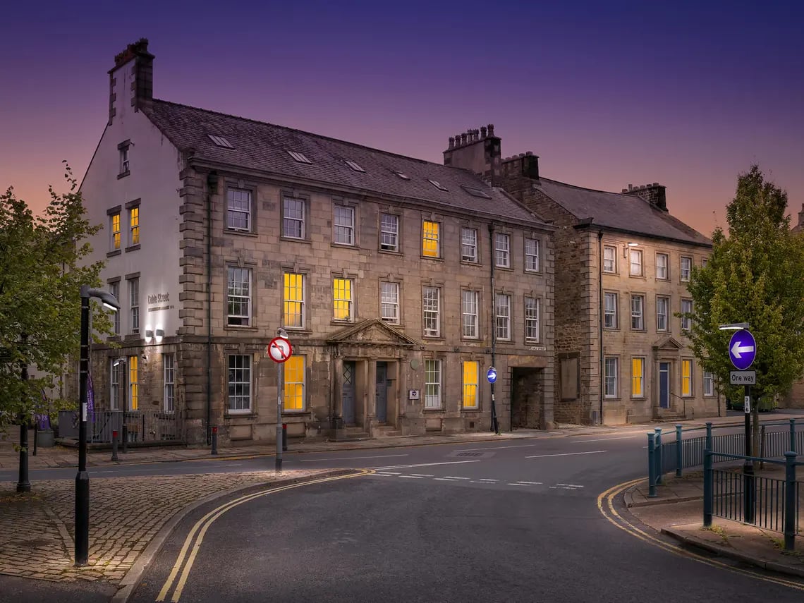 Historic buildings with lit windows exterior at Cable Street Lancaster in Lancaster Student Accommodation