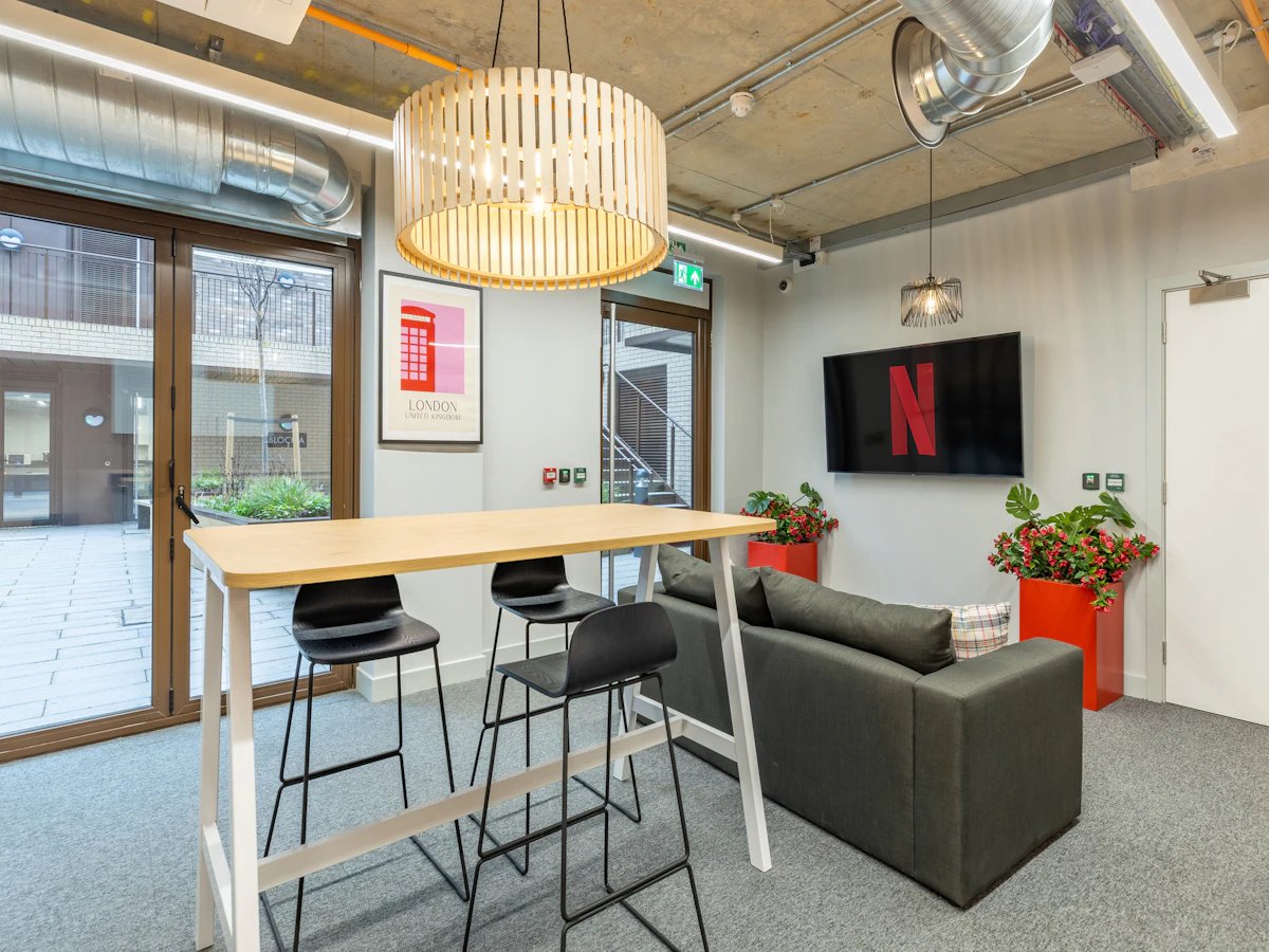Dining table sofa television with Netflix living area at Venue Studios in London Student Accommodation