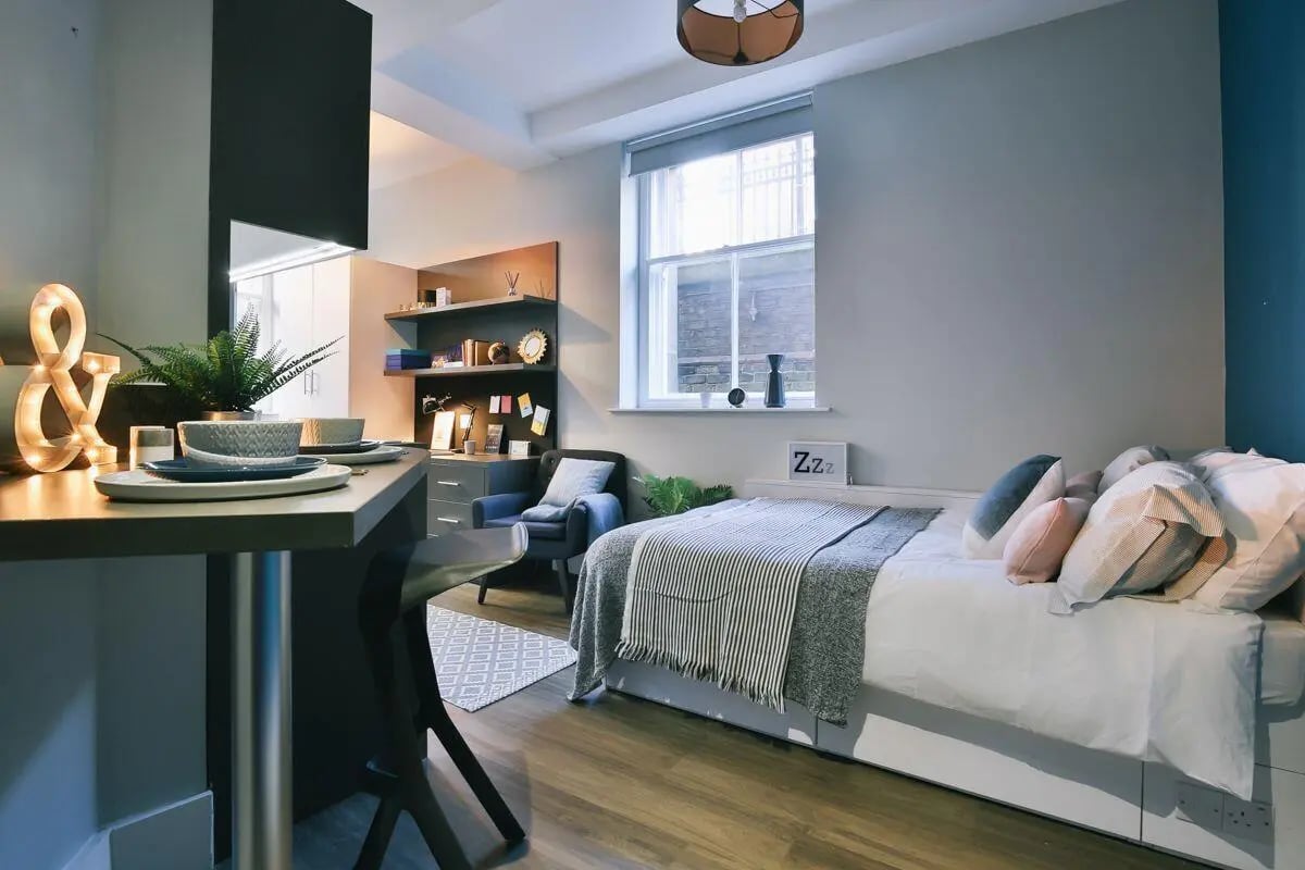Desk chair bed shelves and decor studio room at The Hahnemann Building in Liverpool Student Accommodation
