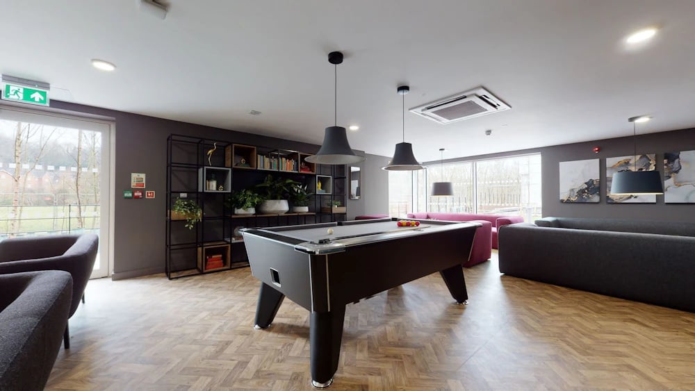 Pool table sofas bookshelves living area at One London Road in Newcastle Under Lyme Student Accommodation