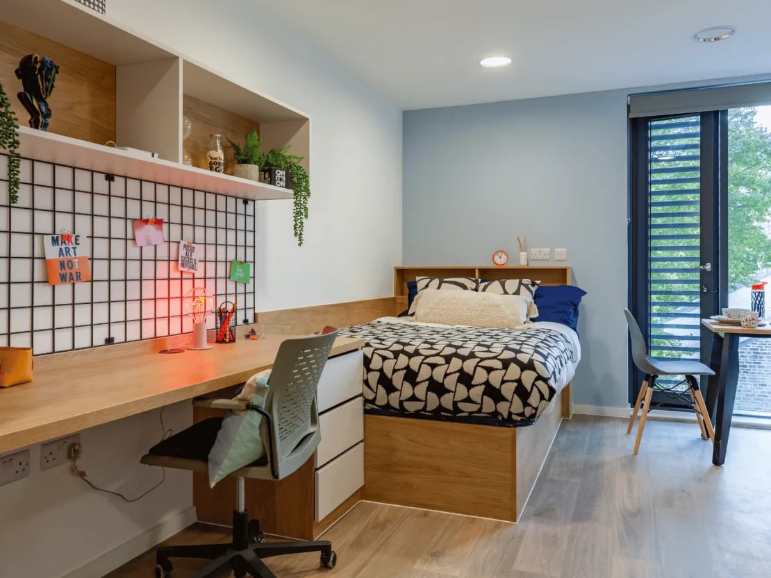 Bed desk chair plants and shelves bedroom at Ty Nant in Swansea Student Accommodation