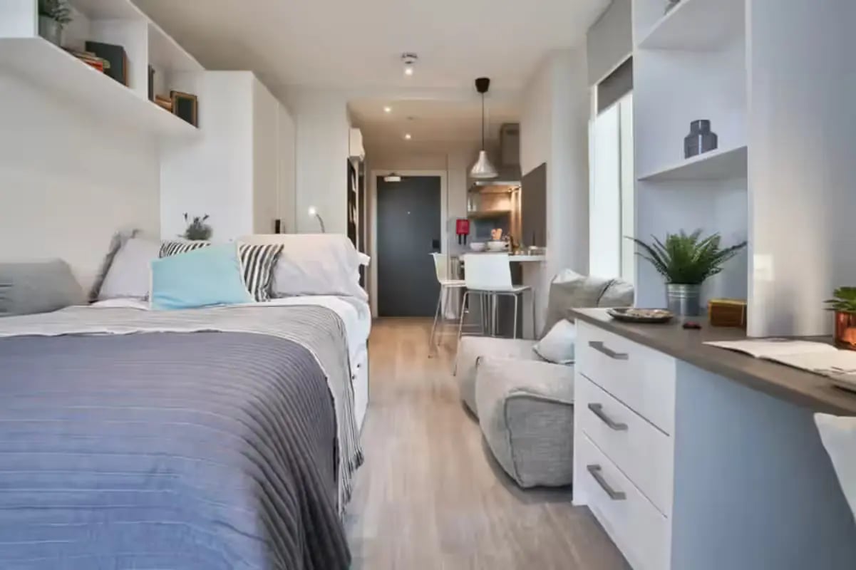 Bed sofa kitchen cabinets and shelving studio apartment at The Emporium Birmingham in Birmingham Student Accommodation