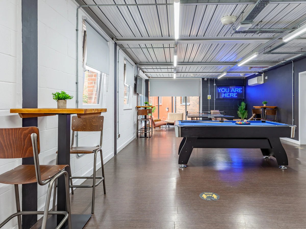 Pool table with seating and neon sign communal area at The Glassworks Newcastle in Newcastle Upon Tyne Student Accommodation
