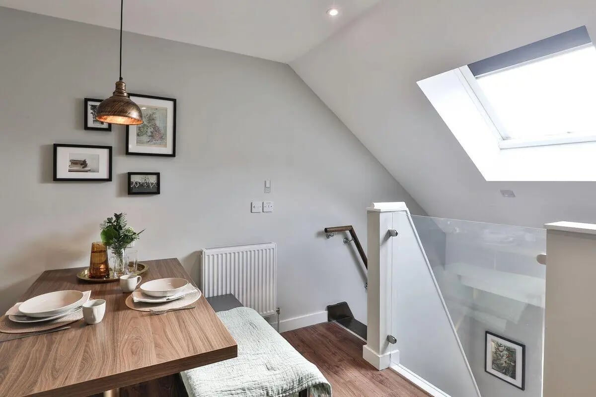 Dining table with place settings and bench living room at St Mary's in Bristol Student Accommodation