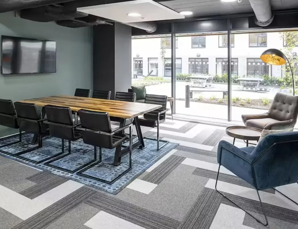 Conference table with chairs and lounge seating communal area at Pittodrie Street in Aberdeen Student Accommodation