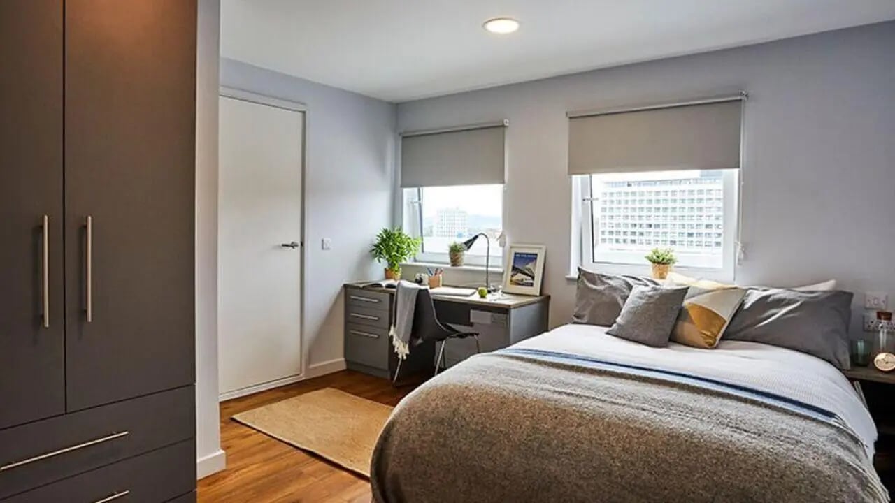 Wardrobe desk bed windows and plant bedroom at iQ Collingwood in Newcastle Upon Tyne Student Accommodation