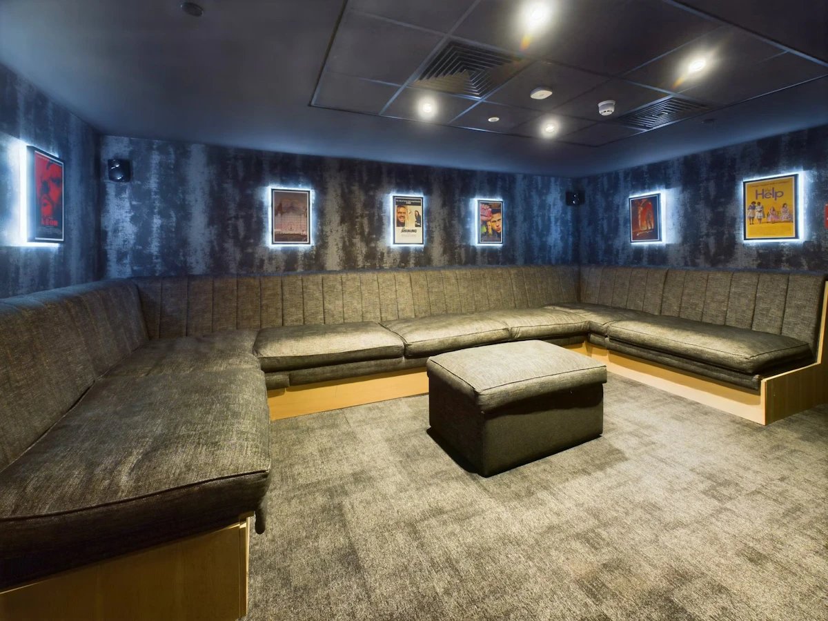 L-shaped sofa ottoman movie posters common area at Crown Place - Nottingham in Nottingham Student Accommodation