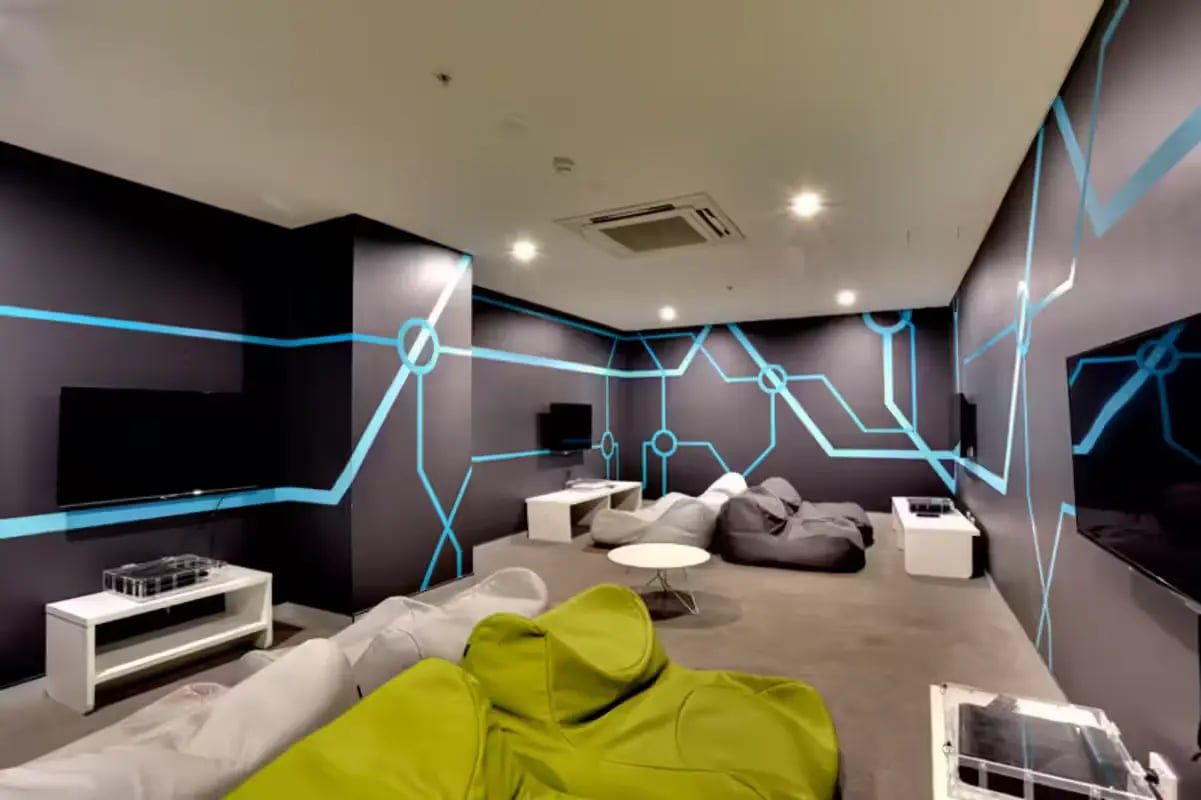 Bean bags and TVs in a modern lounge at Scape at University of Sydney in Sydney Student Accommodation
