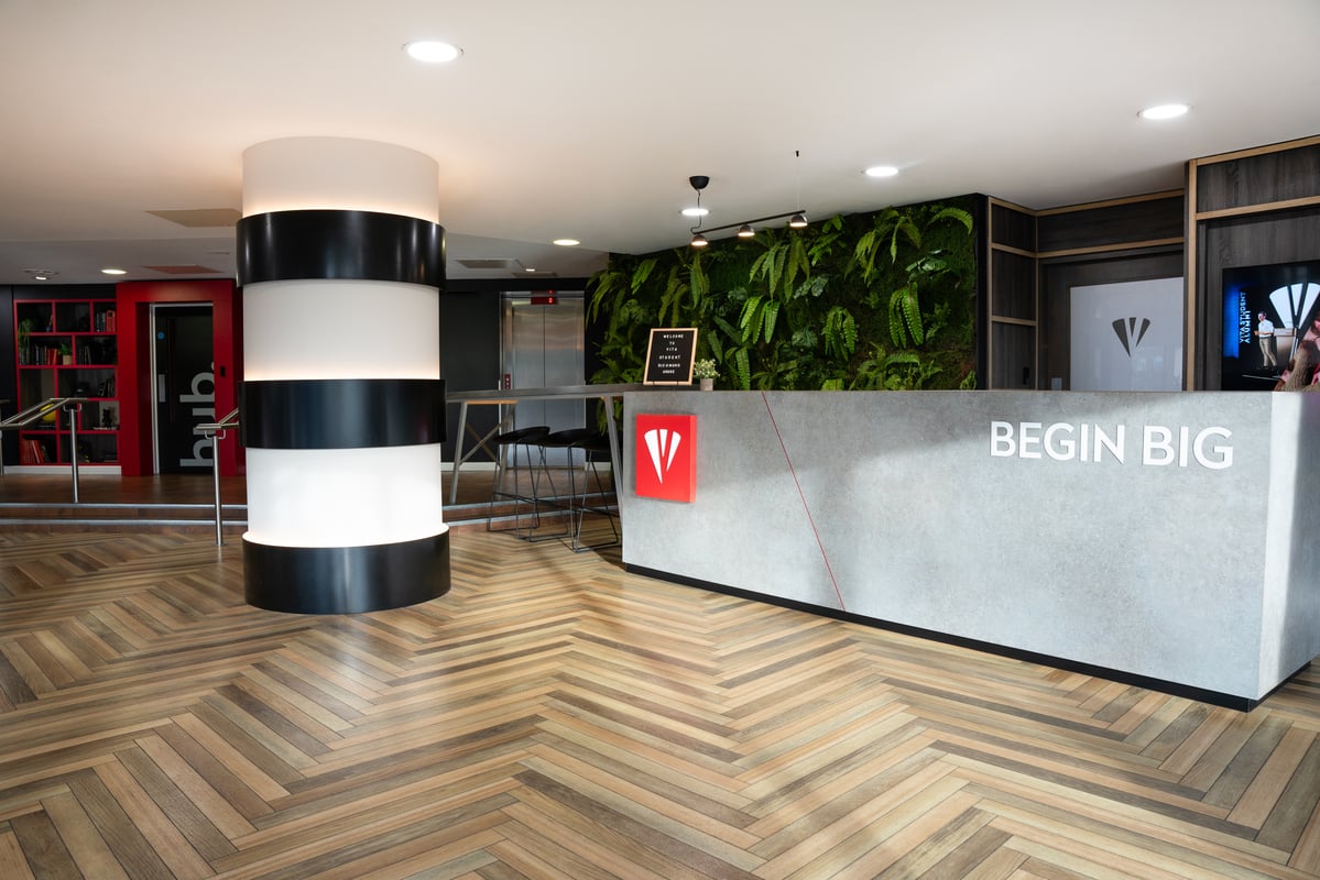 Reception desk with vertical garden living area at Vita Student Richmond House in Southampton Student Accommodation
