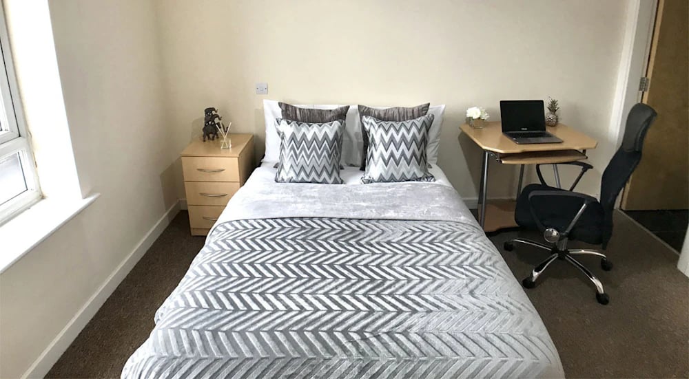 Bed with desk and chair bedroom at Hassells Bridge House in Newcastle Under Lyme Student Accommodation